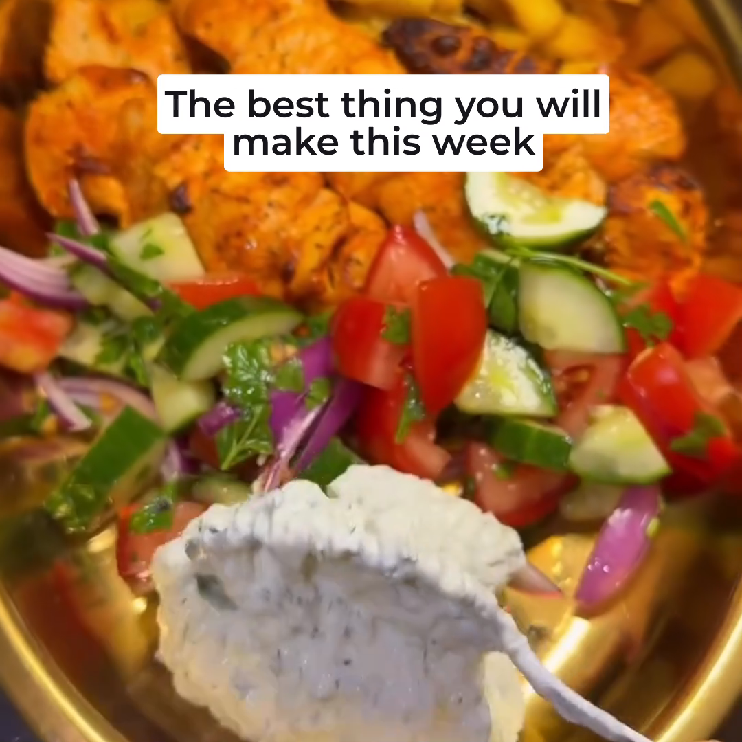 Golden chicken shish with chopped cucumber and tomato salad, chips and homemade tzatziki
